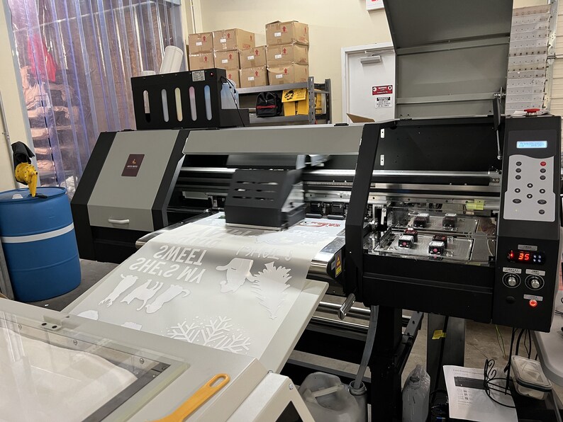 Industrial DTF (Direct to Fabric) printer used to print gang roll transfers.